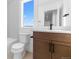 Bright bathroom featuring a modern vanity, sleek fixtures, and a large window with scenic views at 14241 Currant, Broomfield, CO 80020