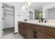 Modern bathroom featuring a double vanity, cabinets, and walk-in closet at 14241 Currant, Broomfield, CO 80020