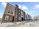 Contemporary townhome row with varied facade colors and a wintery landscape view at 14241 Currant, Broomfield, CO 80020