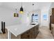 Kitchen island with pendant lights and quartz counters providing style and functionality at 14241 Currant, Broomfield, CO 80020
