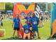 Group of runners poses at a community event with an artistic heart-shaped backdrop on a grassy area at 1652 N Lafayette St # 6, Denver, CO 80218