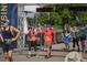People crossing the finish line of an outdoor race with electronic timers and sponsor banners at 1652 N Lafayette St # 6, Denver, CO 80218