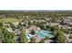 Aerial view of community showcasing pool, tennis courts, beautiful landscaping, and city skyline at 5765 W Atlantic Pl # 103, Lakewood, CO 80227