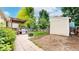 Large backyard with a patio, deck, storage shed, and mature trees at 1750 Clark Dr, Erie, CO 80516