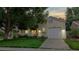Charming yellow home featuring an attached garage and well-maintained lawn at 1750 Clark Dr, Erie, CO 80516