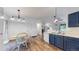 Eat in kitchen with hardwood floors and blue cabinets at 1750 Clark Dr, Erie, CO 80516