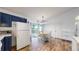 Bright kitchen with white appliances, hardwood flooring and open layout at 1750 Clark Dr, Erie, CO 80516