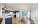 Open kitchen showcasing blue cabinets, eat in dining area and modern appliances at 1750 Clark Dr, Erie, CO 80516