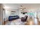 Comfortable living room featuring hardwood floors, blue sofa and a ceiling fan at 1750 Clark Dr, Erie, CO 80516