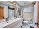 The bathroom features a double sink vanity, modern fixtures, and a stylish mirror at 1025 Zang St, Golden, CO 80401