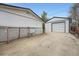 Spacious driveway leading to a detached garage with space for parking and storage at 1025 Zang St, Golden, CO 80401