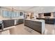 Spacious kitchen with an island and modern appliances, seamlessly connecting to the living area at 1025 Zang St, Golden, CO 80401