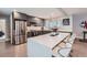 Modern kitchen with stainless steel appliances, gray cabinetry, large center island and bar stool seating at 1025 Zang St, Golden, CO 80401