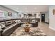 Open-concept living area with a comfortable leather sofa, modern decor, and access to the kitchen at 1025 Zang St, Golden, CO 80401