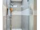 The walk-in shower features light gray tiles, a built-in shelf, and modern fixtures at 1025 Zang St, Golden, CO 80401