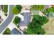 Overhead view of property with mature landscaping, tennis court, and circular driveway at 7440 Quail St, Arvada, CO 80005