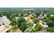 View of property location amidst lush trees and neighborhood, featuring a tennis court on the lot at 7440 Quail St, Arvada, CO 80005