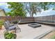 Backyard with custom outdoor fire pit featuring built-in seating offers a cozy space for gatherings and relaxation at 7440 Quail St, Arvada, CO 80005