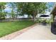 Expansive backyard with mature trees, a sprawling lawn and patio, perfect for outdoor activities and relaxation at 7440 Quail St, Arvada, CO 80005