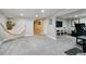 Spacious basement with a cozy hammock, entertainment center, and workout area perfect for relaxing or exercising at 7440 Quail St, Arvada, CO 80005