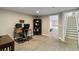 Finished basement with desk, bookcase, and view to bedroom at 7440 Quail St, Arvada, CO 80005