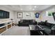 Finished basement features a comfortable lounge area with a large sofa and entertainment center, perfect for relaxation at 7440 Quail St, Arvada, CO 80005