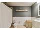 Neutral toned bathroom featuring modern fixtures, stylish accents, and a shower for comfortable bathing at 7440 Quail St, Arvada, CO 80005