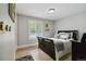 Bedroom featuring a bed with gray bedding, a dark wood frame, and a window at 7440 Quail St, Arvada, CO 80005