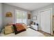 Light-filled bedroom featuring a large window, closet, and colorful pillows at 7440 Quail St, Arvada, CO 80005