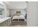 Bedroom with storage under the bed and adjoined to a bathroom with a marble countertop at 7440 Quail St, Arvada, CO 80005