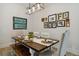 Charming dining room featuring a wood table, chairs, and framed artwork at 7440 Quail St, Arvada, CO 80005