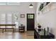 Bright entryway with white walls, hardwood floors, and stylish furniture pieces at 7440 Quail St, Arvada, CO 80005