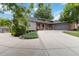 Well-maintained ranch-style home with an extended driveway, lush lawn and landscaping at 7440 Quail St, Arvada, CO 80005