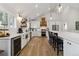 Bright, all-white kitchen with stainless steel appliances and eat-in bar at 7440 Quail St, Arvada, CO 80005