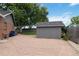 Backyard features a gray shed with a gravel base providing practical storage space at 7440 Quail St, Arvada, CO 80005