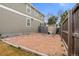 Large backyard with dog run, mature trees, and partially fenced for outdoor enjoyment at 4221 Pioneer Pl, Brighton, CO 80601