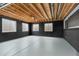 Unfinished basement space featuring painted concrete floor, exposed joists, and multiple windows at 4221 Pioneer Pl, Brighton, CO 80601