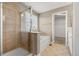 Bathroom with shower, soaking tub, and tan ceramic tile at 4221 Pioneer Pl, Brighton, CO 80601