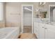 Main bathroom featuring soaking tub, double vanity, and walk-in closet at 4221 Pioneer Pl, Brighton, CO 80601