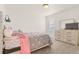 Bedroom featuring carpet, bed with grey and pink comforter, dresser, and window at 4221 Pioneer Pl, Brighton, CO 80601