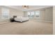 Spacious main bedroom with large windows and neutral carpeting at 4221 Pioneer Pl, Brighton, CO 80601