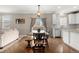 Well-lit dining area with a wooden table and bench seating, adjacent to the modern kitchen at 4221 Pioneer Pl, Brighton, CO 80601