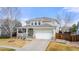 Well-manicured two-story home with a covered porch, two-car garage, and low-maintenance landscaping at 4221 Pioneer Pl, Brighton, CO 80601