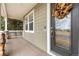 Inviting covered porch with decorative wreath on front door, offering a cozy entryway at 4221 Pioneer Pl, Brighton, CO 80601