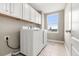Bright laundry room with tile floors, window and includes a washer and dryer at 4221 Pioneer Pl, Brighton, CO 80601