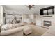 Open concept living room connected to a modern kitchen, featuring a fireplace and comfortable seating at 4221 Pioneer Pl, Brighton, CO 80601