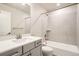 Bright bathroom features a shower over the tub and a gray vanity with white countertops at 9771 Rosalee Peak St, Littleton, CO 80125