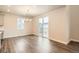 Bright dining area with hardwood floors, modern chandelier, and sliding door access to the backyard at 9771 Rosalee Peak St, Littleton, CO 80125