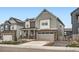 Two-story home boasting gray siding, brick accents, and a two-car garage at 9771 Rosalee Peak St, Littleton, CO 80125