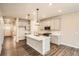 Modern kitchen with white cabinets, stainless steel appliances, and a center island at 9771 Rosalee Peak St, Littleton, CO 80125